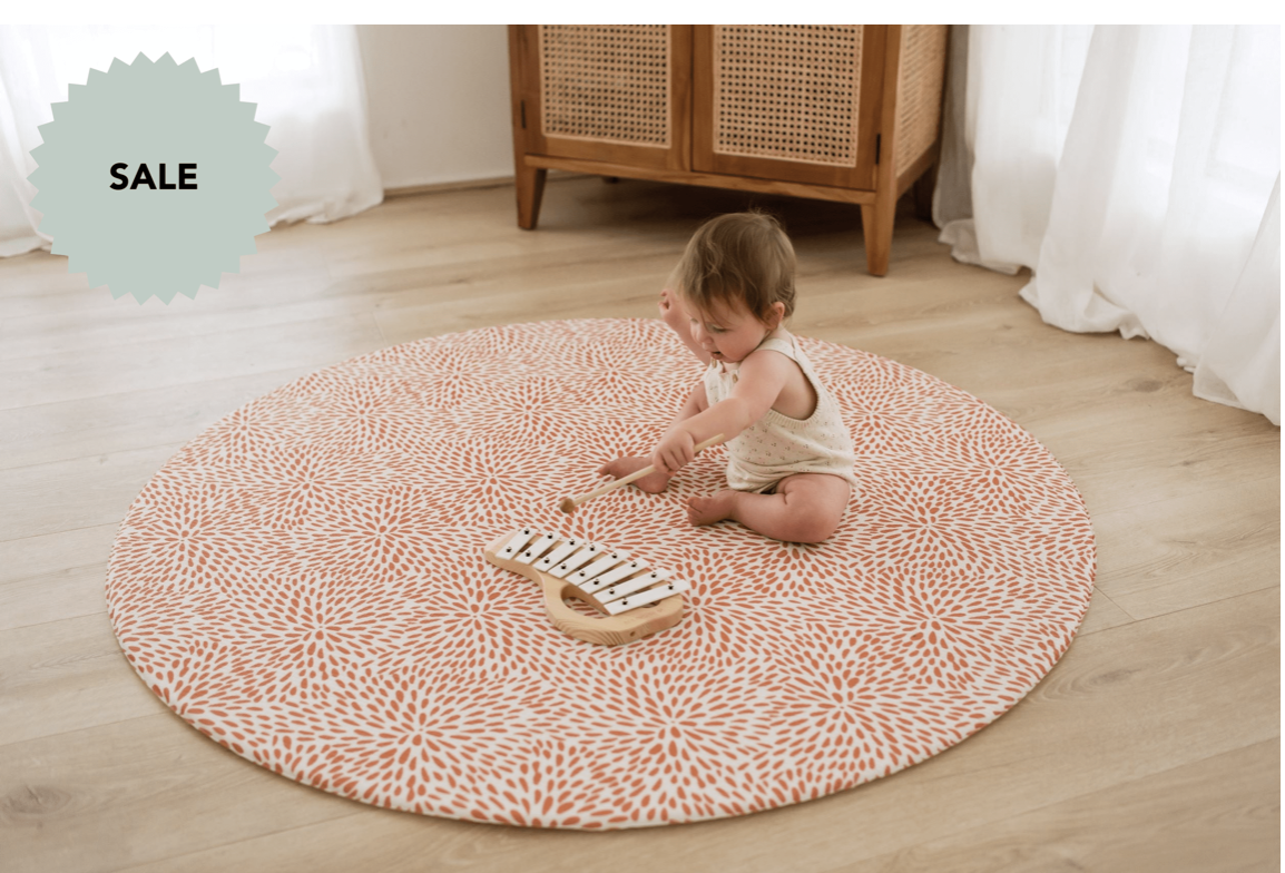 ROUND: RUST PETAL / NEUTRAL PALM LEAF PLAY MAT